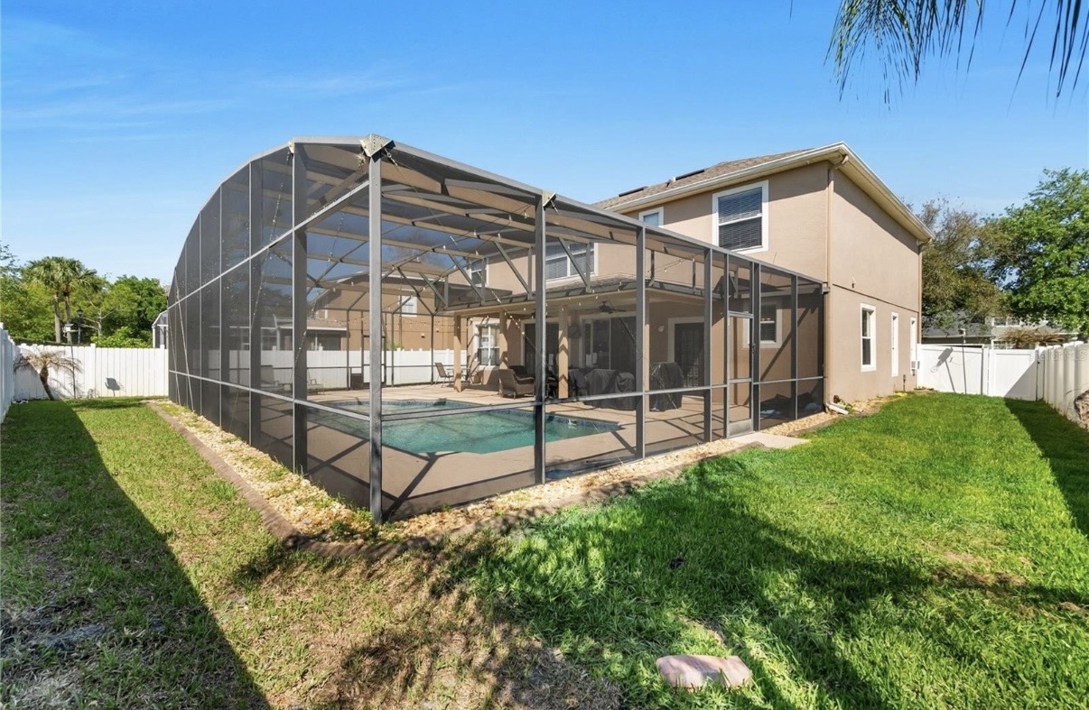 Backyard with screened pool enclosure